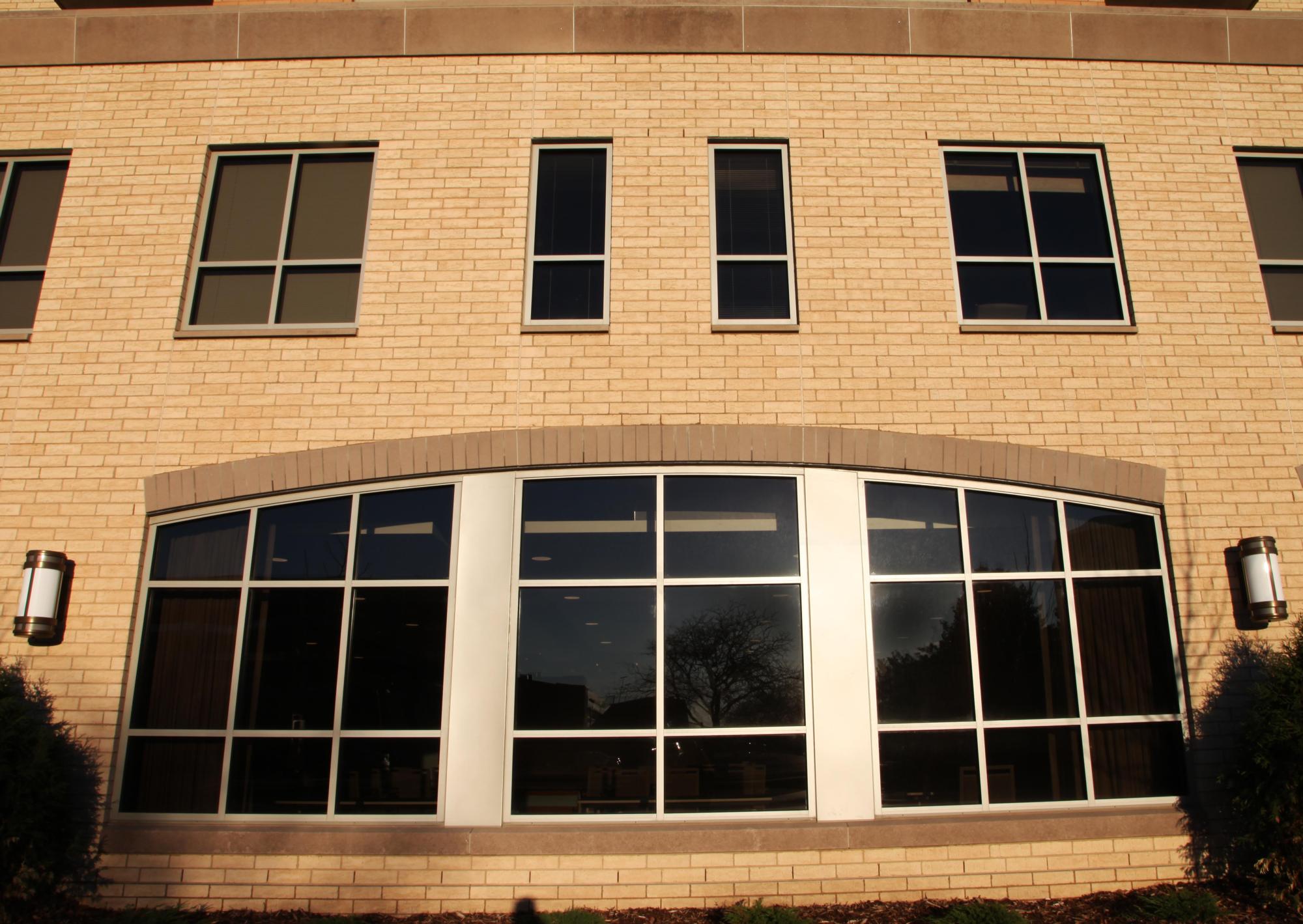 A photograph of the brick wall and windows of the Aurora on France